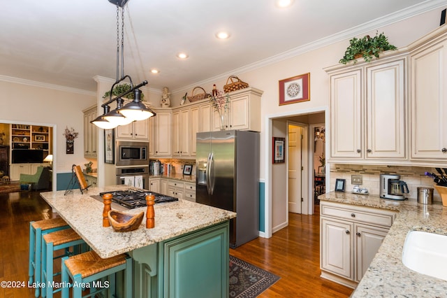 kitchen featuring hanging light fixtures, a breakfast bar area, a kitchen island, light stone counters, and stainless steel appliances