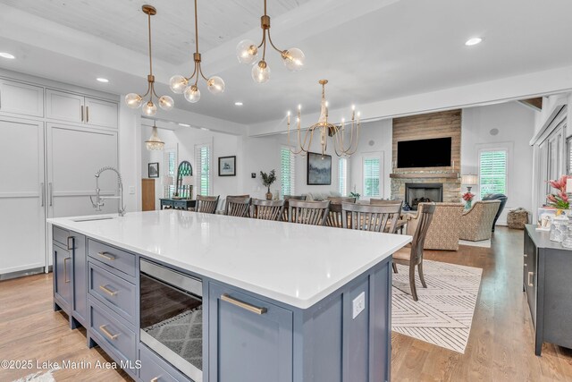 116 Glynmere Park, Alexander City, AL 35010 - kitchen featuring a sink, a chandelier, open floor plan, light wood-style floors, and light countertops