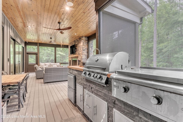 116 Glynmere Park, Alexander City, AL 35010 - sunroom / solarium featuring a ceiling fan, an outdoor living space with a fireplace, and exterior kitchen
