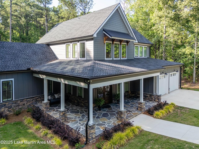 116 Glynmere Park, Alexander City, AL 35010 - view of front of house featuring roof with shingles, board and batten siding, driveway, a garage, and stone siding