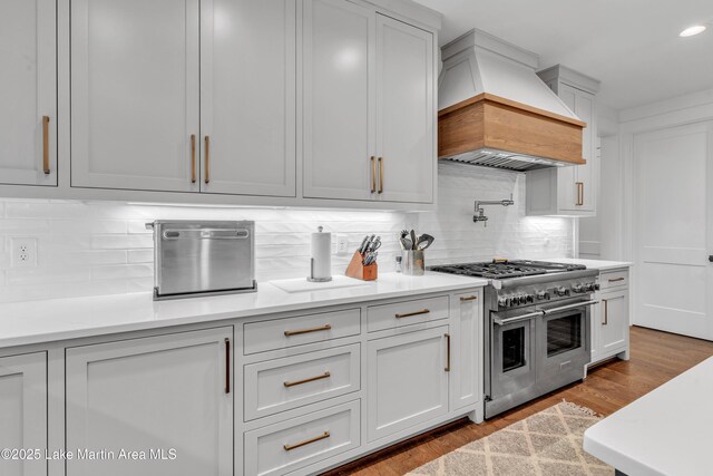 116 Glynmere Park, Alexander City, AL 35010 - kitchen featuring double oven range, custom exhaust hood, decorative backsplash, light countertops, and recessed lighting