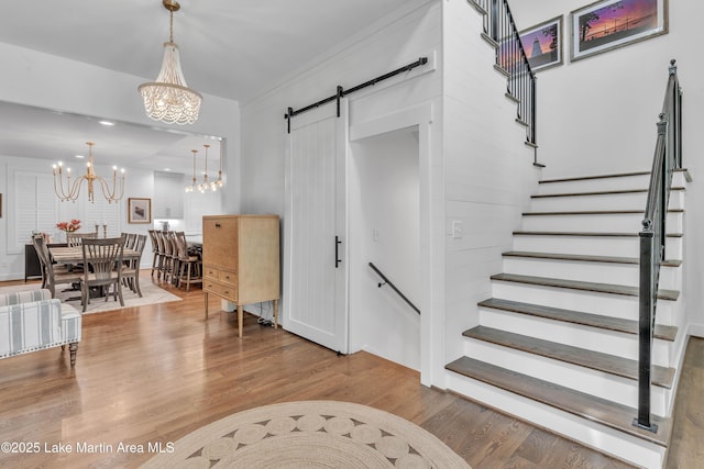 116 Glynmere Park, Alexander City, AL 35010 - stairs with a chandelier, wood finished floors, and a barn door