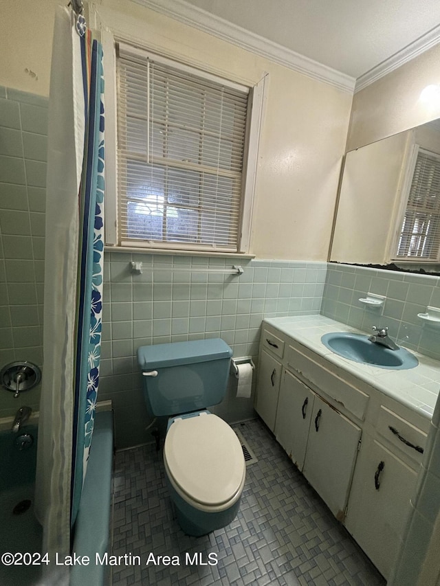 full bathroom with vanity, toilet, ornamental molding, and tile walls