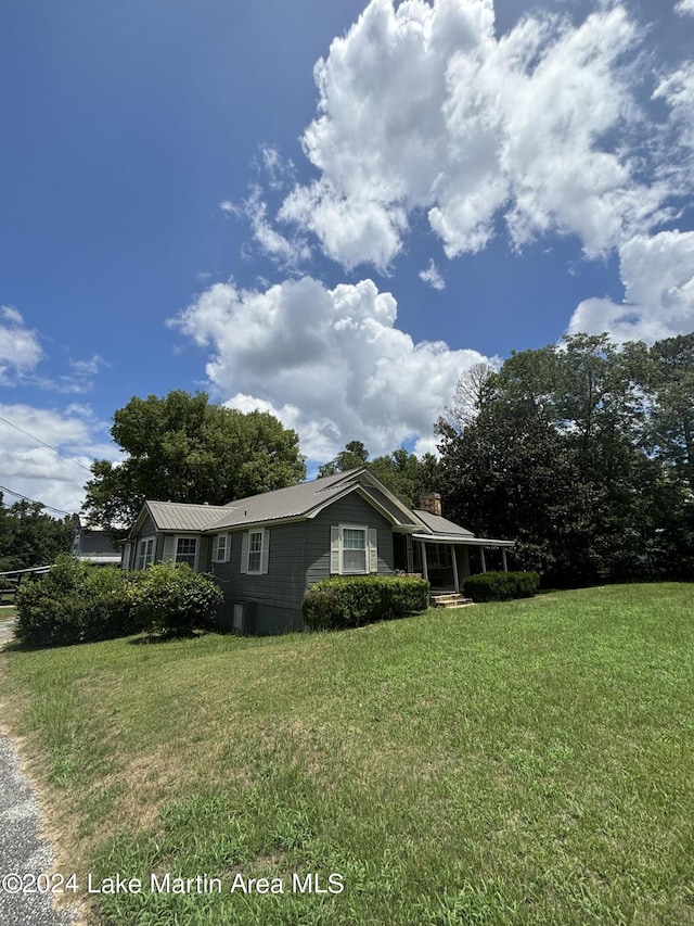 view of side of home featuring a lawn