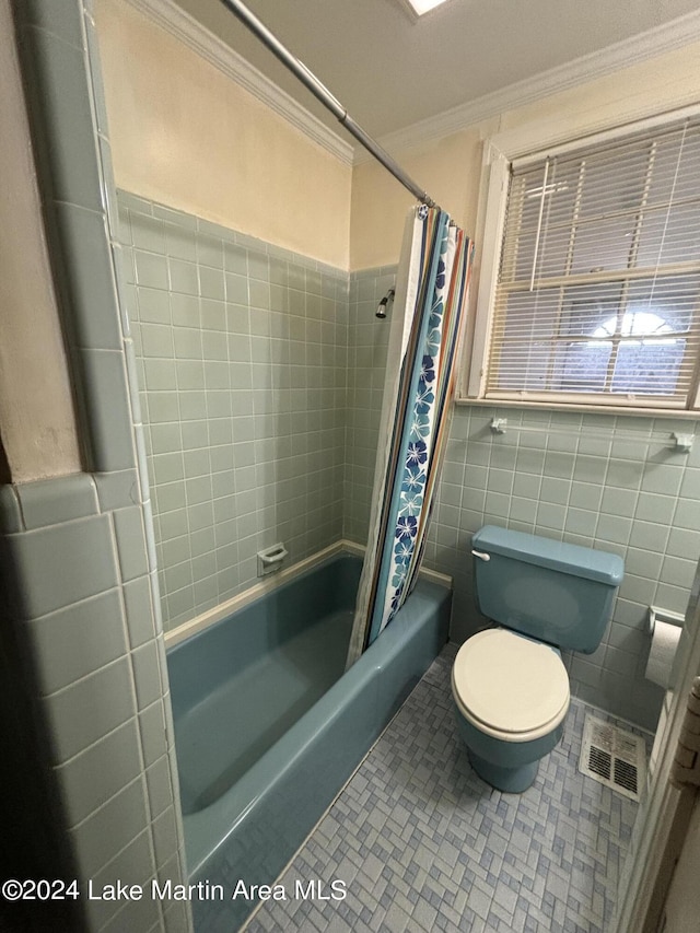 bathroom featuring tile patterned flooring, toilet, crown molding, and tile walls