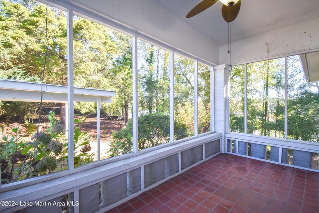 unfurnished sunroom featuring ceiling fan and a healthy amount of sunlight