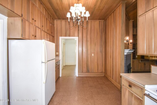 kitchen with a notable chandelier, white refrigerator, decorative light fixtures, wooden walls, and wood ceiling