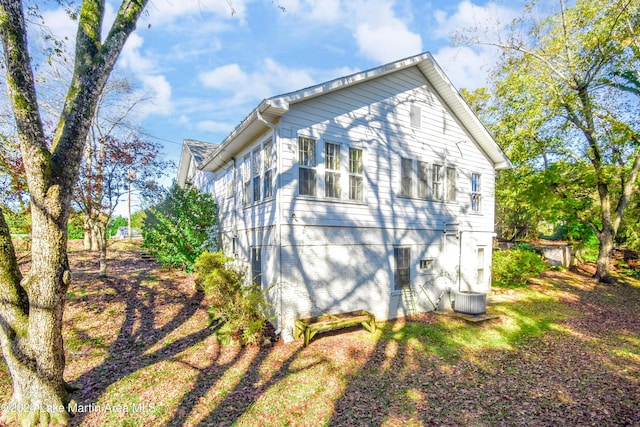 view of side of home with central air condition unit