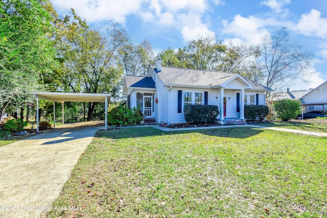 view of front of home with a front lawn and a carport