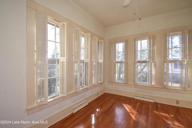 unfurnished sunroom with baseboard heating and a healthy amount of sunlight