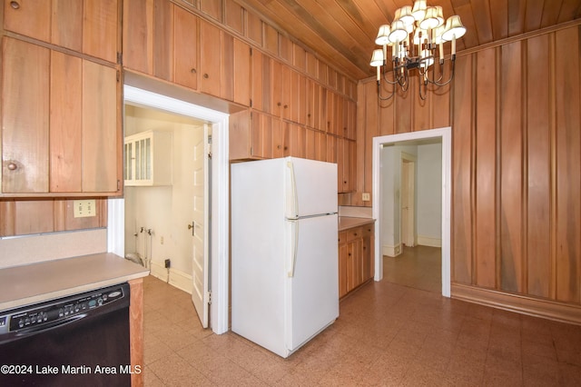 kitchen featuring an inviting chandelier, black dishwasher, white fridge, wooden walls, and wood ceiling