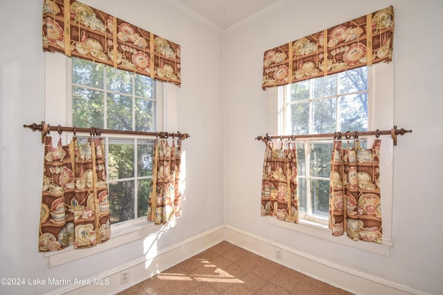 interior space featuring tile patterned flooring and ornamental molding