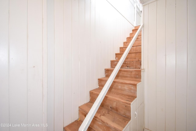 stairway with wood walls