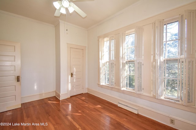 spare room featuring ceiling fan, dark hardwood / wood-style flooring, a healthy amount of sunlight, and ornamental molding