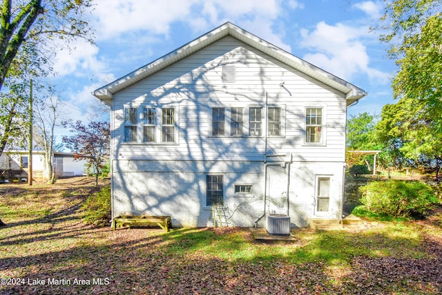 rear view of house featuring central AC unit