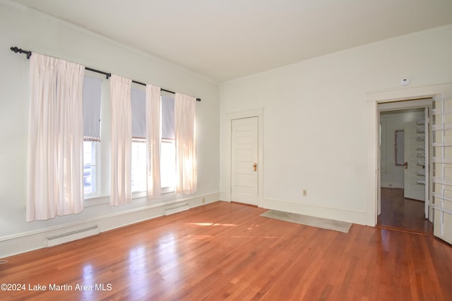 unfurnished room with hardwood / wood-style flooring