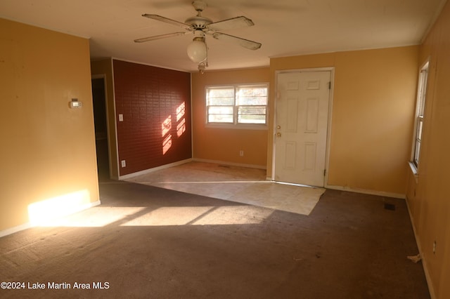 spare room featuring light colored carpet and ceiling fan