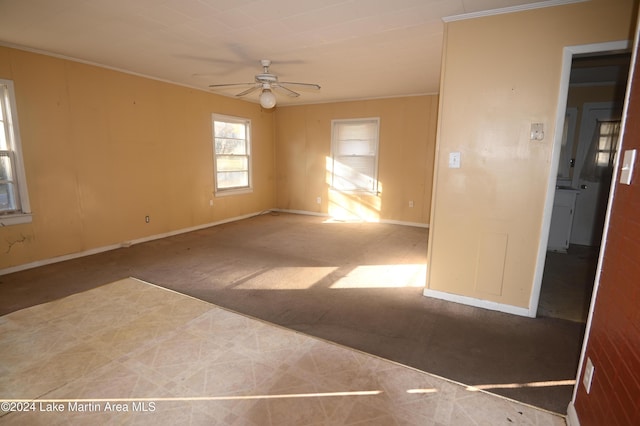 unfurnished room with ceiling fan, ornamental molding, and wood walls