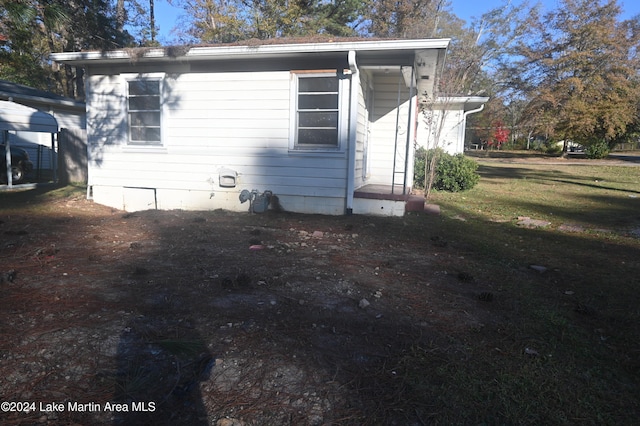 rear view of house with a yard