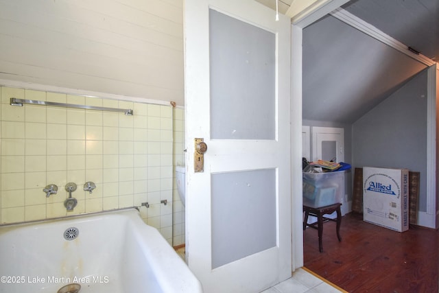 full bathroom featuring a bathtub and vaulted ceiling