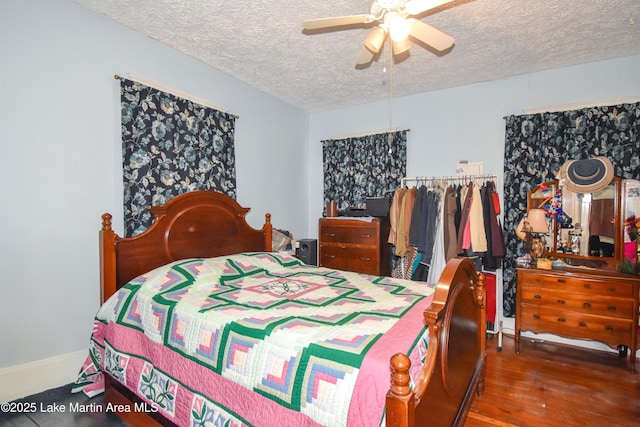 bedroom with ceiling fan, a textured ceiling, and wood finished floors