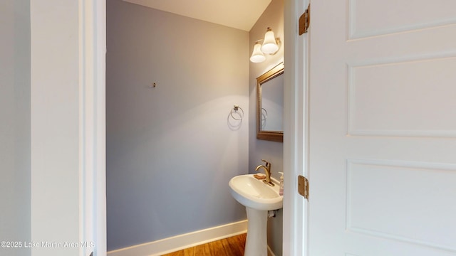 bathroom with baseboards and wood finished floors