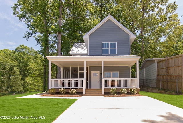view of front facade featuring a porch, fence, and a front lawn