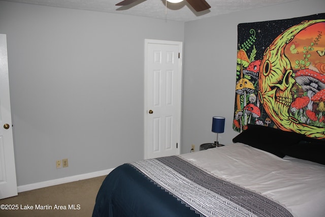 carpeted bedroom featuring ceiling fan, baseboards, and a textured ceiling