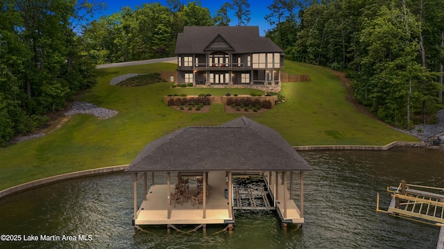 101 Mason Rd, Tallassee, AL 36078 - rear view of property with boat lift, a shingled roof, a water view, and a lawn