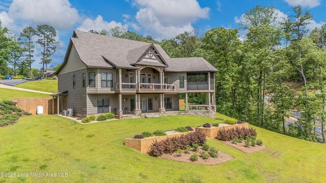 101 Mason Rd, Tallassee, AL 36078 - rear view of property featuring a patio, cooling unit, a wooden deck, a lawn, and a shingled roof