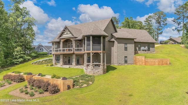 101 Mason Rd, Tallassee, AL 36078 - back of property with a sunroom, a patio area, roof with shingles, and a lawn