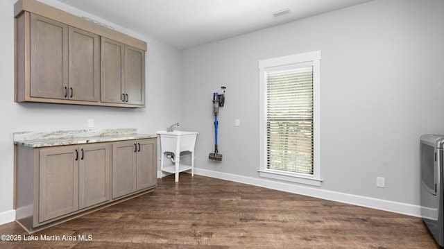 101 Mason Rd, Tallassee, AL 36078 - clothes washing area with cabinet space, baseboards, washer / clothes dryer, and dark wood-style floors