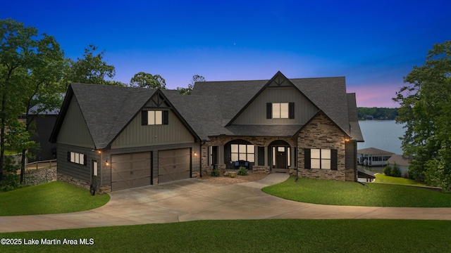 101 Mason Rd, Tallassee, AL 36078 - french country home featuring covered porch, roof with shingles, stone siding, a yard, and concrete driveway