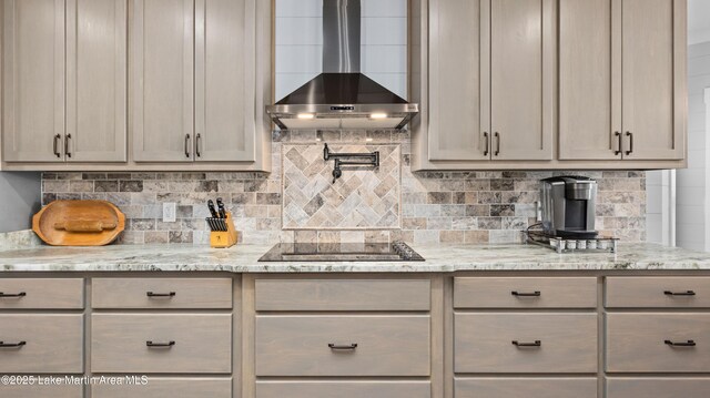 101 Mason Rd, Tallassee, AL 36078 - kitchen with black electric cooktop, wall chimney range hood, decorative backsplash, and light stone counters