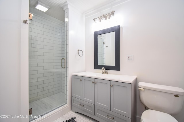 bathroom featuring tile patterned floors, toilet, a shower with door, vanity, and ornamental molding