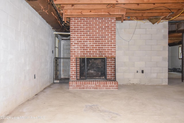 basement featuring a brick fireplace