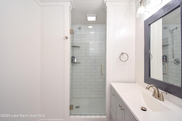 bathroom featuring vanity and an enclosed shower