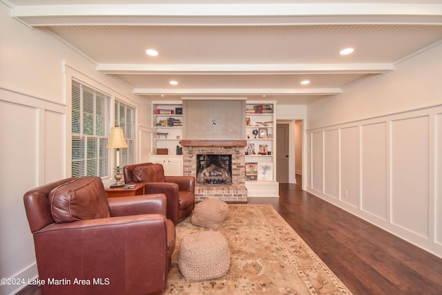 living room featuring beam ceiling, built in shelves, and dark hardwood / wood-style floors