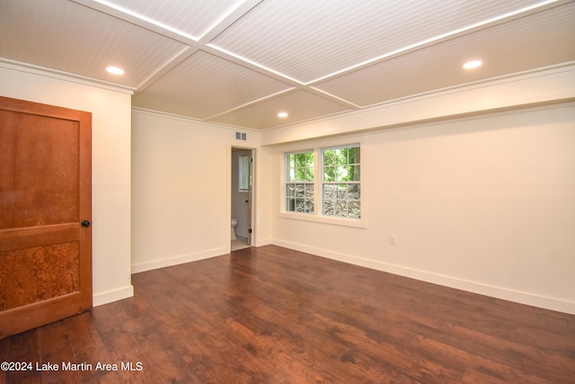 empty room featuring crown molding and dark wood-type flooring