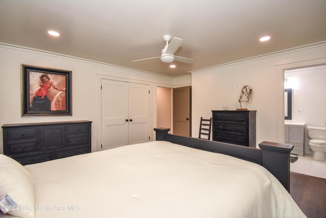 bedroom featuring dark hardwood / wood-style flooring, ensuite bathroom, ornamental molding, ceiling fan, and a closet