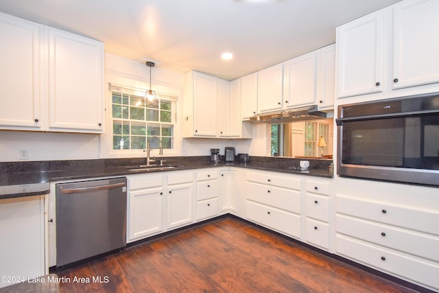 kitchen with dark hardwood / wood-style flooring, white cabinetry, sink, and appliances with stainless steel finishes