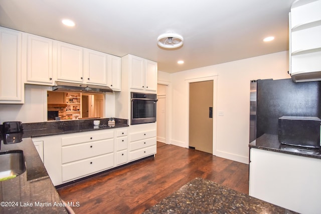 kitchen with black oven, white cabinetry, dark hardwood / wood-style flooring, and sink