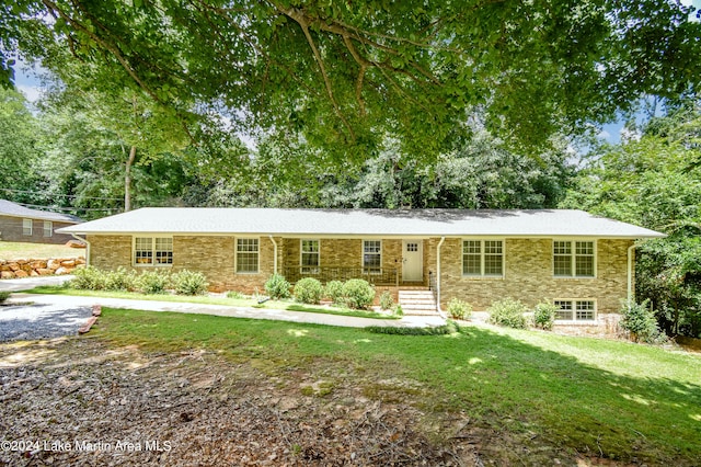 single story home with a porch and a front lawn