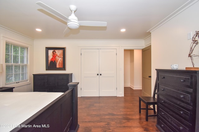 bedroom with ornamental molding, a closet, ceiling fan, and dark wood-type flooring