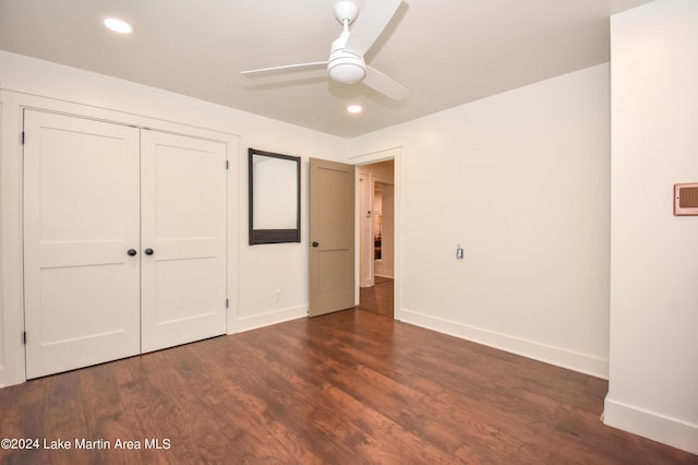 unfurnished bedroom featuring ceiling fan, a closet, and dark hardwood / wood-style floors