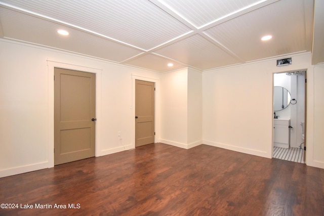 spare room with dark hardwood / wood-style floors, ornamental molding, and coffered ceiling