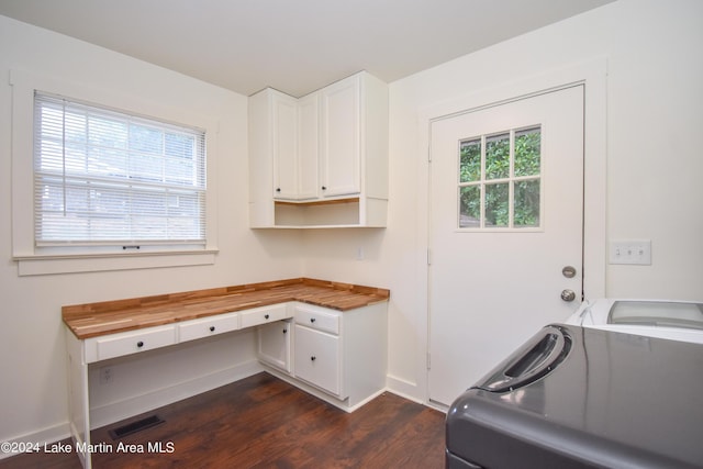 laundry room with dark wood-type flooring and a healthy amount of sunlight