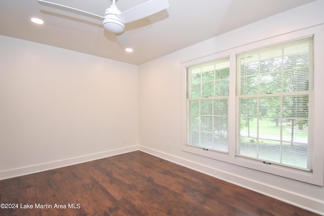 empty room with ceiling fan and dark wood-type flooring