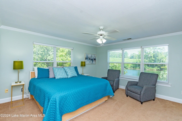 bedroom with carpet flooring, ceiling fan, crown molding, and a textured ceiling