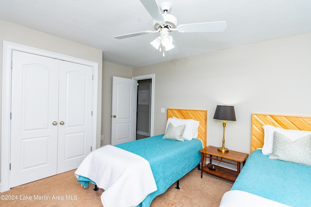 carpeted bedroom with a closet and ceiling fan